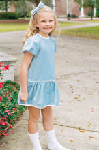 Load image into Gallery viewer, The Harper Dress captures effortless elegance in sumptuous Beaufort blue velvet. Designed for girls ages 5–8, this charming piece features an oversized back bow—a subtle yet striking detail that elevates any occasion. Whether she's attending a fall celebration or holiday gathering, the luxurious velvet drape and thoughtful silhouette make this dress a wardrobe essential. A timeless choice for special moments.
