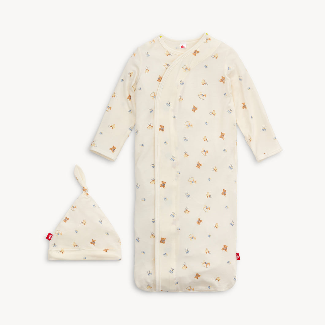 Give the gift of comfort with our Lullaby Lane Gown & Hat Set. Made by Magnetic, this set is perfect for newborns and their parents, making diaper changes a breeze with its soft and cozy material. A must-have for any nursery wardrobe.