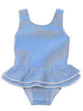 Load image into Gallery viewer, Bring the charm of Paris to the beach with this adorable skirted swimsuit. The blue and white seersucker stripes and white mini pompom accents give it a stylish and playful look. The airy open back with a bow detail adds a cute flair. Perfect for any fashionable toddler girl! From SnapperRock.
