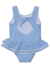 Load image into Gallery viewer, Bring the charm of Paris to the beach with this adorable skirted swimsuit. The blue and white seersucker stripes and white mini pompom accents give it a stylish and playful look. The airy open back with a bow detail adds a cute flair. Perfect for any fashionable toddler girl! From SnapperRock.
