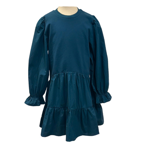 The Cece Dress in Dark Cerulean by Pleat combines comfort and style with its tiered skirt and long sleeves gathered at the wrists. Perfectly suited for fall events, this dress offers a flattering silhouette and effortless elegance, making it an ideal choice for your little one’s seasonal wardrobe.