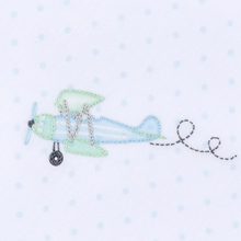 Load image into Gallery viewer, Soar into comfort with this charming Take Flight Embroidered Footie from Magnolia Baby. Crafted from sumptuous Pima cotton, this all-day essential wraps your little one in softness while delicate airplane embroidery dances across a subtle minidots background. Finished with an elegant picot trim, it's the perfect blend of whimsy and sophistication—ideal for playtime, naptime, or any moment in between. Give your child the gift of cozy luxury that feels as wonderful as it looks
