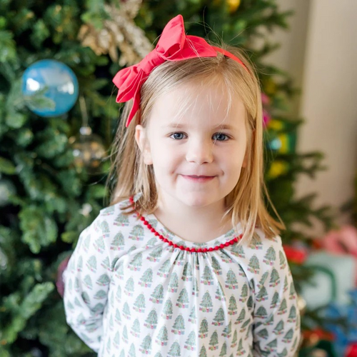 Dress your little one in cozy holiday charm with the Carlin Girls' Lounge Dress from Lila & Hayes. Crafted from soft pima cotton, this long-sleeve dress features a delicate flutter ruffle hem and playful pom pom trim that add festive flair. The whimsical Christmas tree print captures the magic of the season, while the button closure at the back ensures easy dressing. Perfect for lounging or holiday gatherings, this dress combines comfort with joyful style for memorable celebrations.