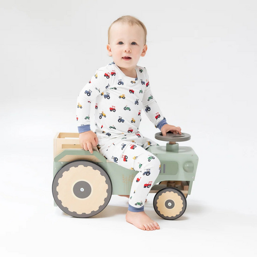 Dress your toddler boy in cozy charm with the Mini Tractors Pajama Set from Angel Dear. Crafted from soft bamboo fabric, this set offers breathable comfort for peaceful sleep. Playful farm animals drive vibrant, colorful tractors, sparking imagination and joy at bedtime. Perfect for little ones who love fun prints and gentle, eco-friendly materials.