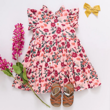 Load image into Gallery viewer, Fresh As A Daisy! A patch of wild daisies in shades of red, orange and white springs from a blush colored ground in our Pink Daisy Floral shown here on our Girls Jennifer Dress. This short sleeve flock favorite silhouette delights with its feminine ruffled neck and sleeves and fully gathered, two tiered skirt that spins like a dream. Invisible zipper. A silver thread woven throughout adds a touch of shimmer and shine. Match back to Little Sis in our Baby Girls Jennifer Bubble.&nbsp;
